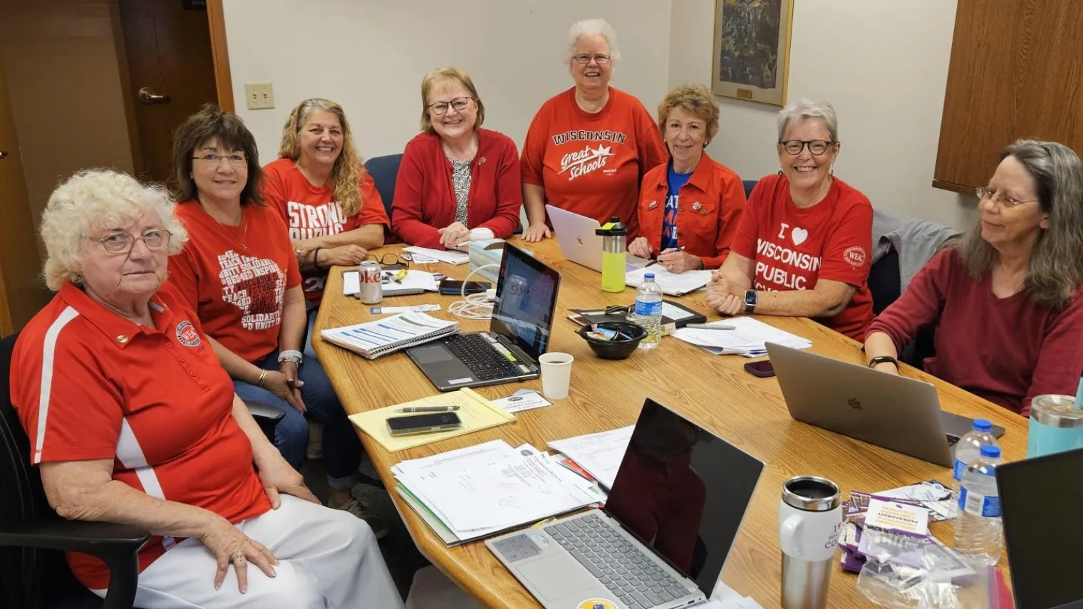 WEAC Retired legislative committee sitting in a conference room all wearing red shirts