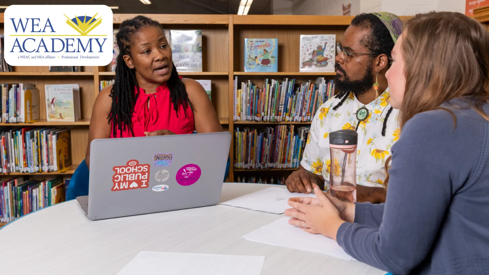 WEA Academy logo with phot of educators working together in library