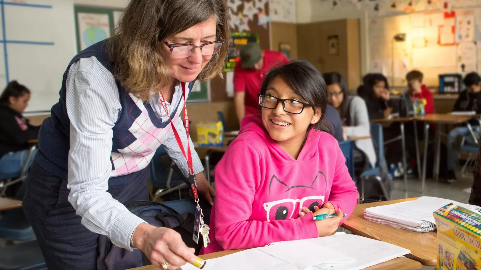 underpaid teacher with student in classroom