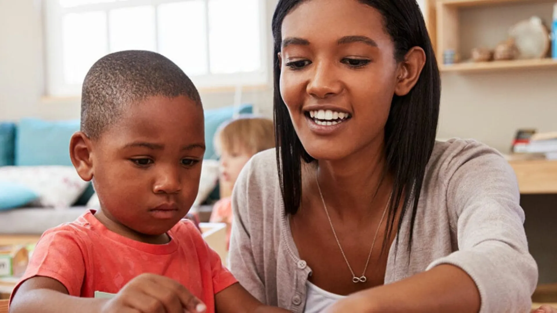Young teacher helping a student with work.