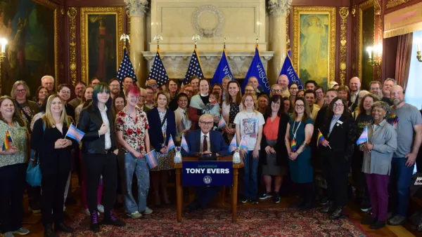 Evers veto signing with LGBTQ supporters