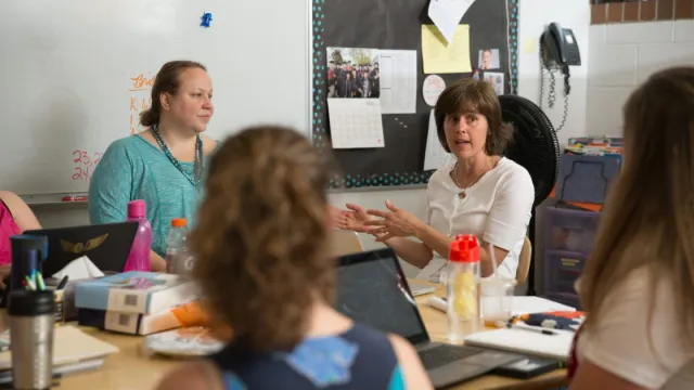 Four women meeting to discuss benefits