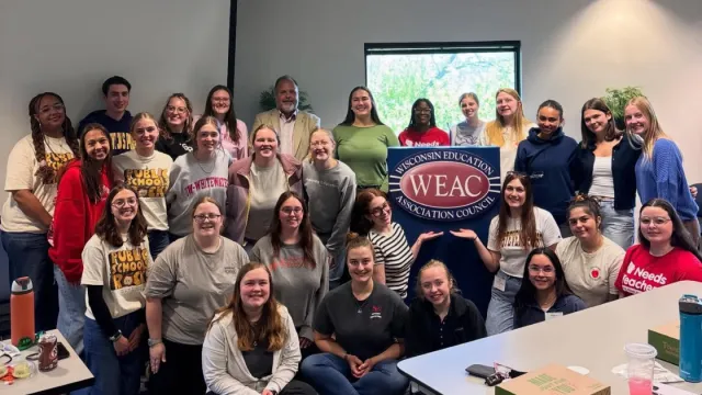 Aspiring educators group photo in WEAC building conference room.